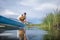 senior male paddler is paddling a stand up paddleboard on a calm lake