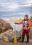 senior male paddler with a wooden canoe paddle on a rock shore of a mountain lake - Horsetooth Reservoir