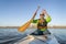 Senior male is paddling expedition canoe