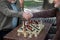 Senior male pensioner congratulating chess opponent by handshake