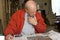 Senior male reading newspaper in his home