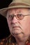 Senior male retired wearing glasses and hat