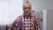 Senior male showing purple ribbon to camera, Alzheimer disease awareness, care