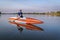 Senior male stand up paddler enjoying sunrise