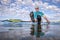 Senior male stand up paddler sitting on a paddleboard