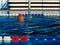 Senior male swimmer in outdoors open pool in blue water
