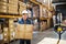 Senior male warehouse worker unloading boxes from a pallet truck.