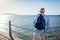 Senior man admiring landscape of Red sea and Tiran island on pier. Traveling concept. Summer vacation