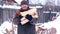 Senior man with ax chopping wood. Carries firewood in his hands