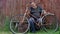 Senior man is being unhappy about very old rust bicycle and ancient wicker basket