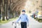 Senior man in blue checked shirt with bicycle in town.