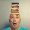 Senior man with books in the head