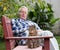 Senior man with cat in courtyard