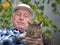 Senior man with cat in courtyard