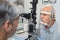 Senior man checking vision with ophtalmologist