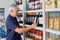 Senior Man Choosing Wine At Supermarket