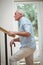 Senior man climbing upstairs with walking stick