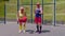 Senior man coach teaching grandmother with basketball dribbling exercise with ball on playground