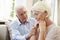 Senior Man Comforting Woman With Depression At Home