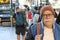 Senior man in crowded train station