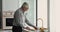 Senior man cutting avocado prepare vegetarian dish in kitchen