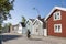 Senior man cycling by wooden houses