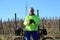 A senior man cyclist with abandoned vineyards behind
