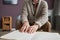 Senior man with disability reading a book in Braille