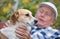 Senior man with dog in courtyard