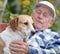 Senior man with dog in courtyard