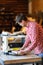 Senior man doing carpentry with edging plane on workbench