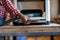 Senior man doing carpentry with edging plane on workbench