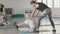 Senior man doing stretching exercise in front of mirror in gym.