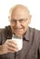 Senior man drinking a glass of milk