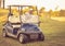 Senior man driving golf car and waving