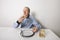 Senior man eating bread spread with sweet jelly jam at table