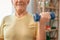 Senior man exercise at home health care with dumbbell in one hand close-up