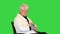 Senior man feeling bad measuring blood pressure on a Green Screen, Chroma Key.