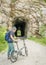 Senior man with a folding bike on Katy Trail at a tunnel near Rocheport, Missouri