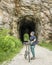 Senior man with a folding bike on Katy Trail at a tunnel near Rocheport, Missouri, summer scenery