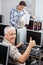 Senior Man Gesturing Thumbs Up At Computer Desk