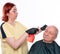 Senior man getting a haircut over white background