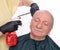 Senior man getting a haircut over white background