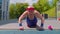 Senior man grandfather 80 years old doing sport cardio training push-ups exercising on playground