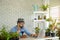 A senior man or grandfather with a mustacheand beard enjoys gardening for the tree at home after retirement