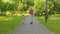 Senior man grandfather tourist riding electric scooter with granddaughter child girl in summer park