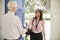 Senior man greeting young woman making home visit