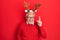 Senior man with grey hair wearing deer christmas hat pointing finger up with successful idea