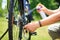 Senior man hands spraying an oil to chain from the wheel bike, doing maintenance of his bicycle