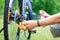 Senior man hands spraying an oil to chain from the wheel bike, doing maintenance of his bicycle